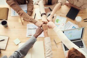 Teamwork fist bump in business meeting